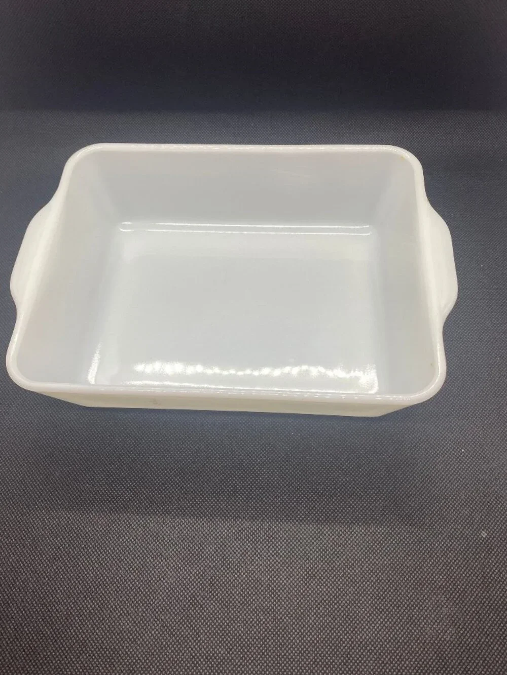 Pyrex White Casserole Dish. Only a small bit of the green design remains. 1 1/2